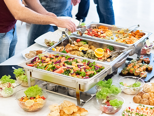 guests serving diverse dishes from a VEVOR chafing dish set at a buffet table with salads and bread.