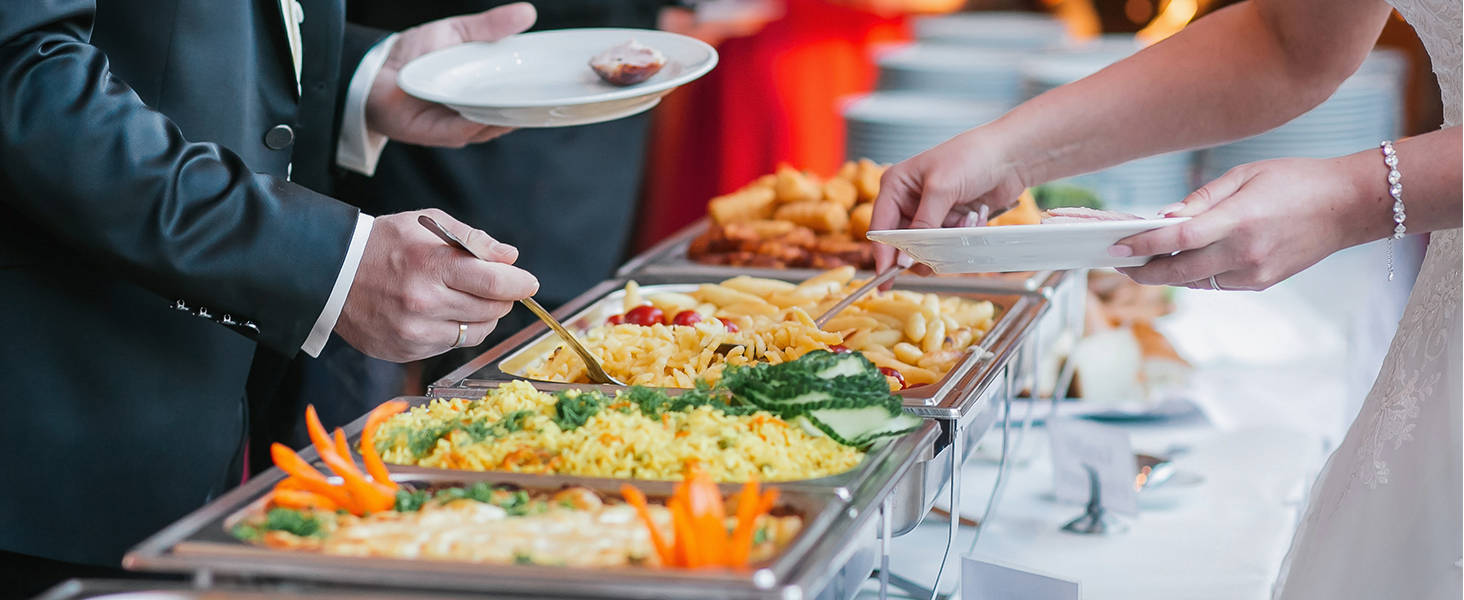 guests serving food from a VEVOR chafing dish set at a buffet, featuring various colorful dishes.