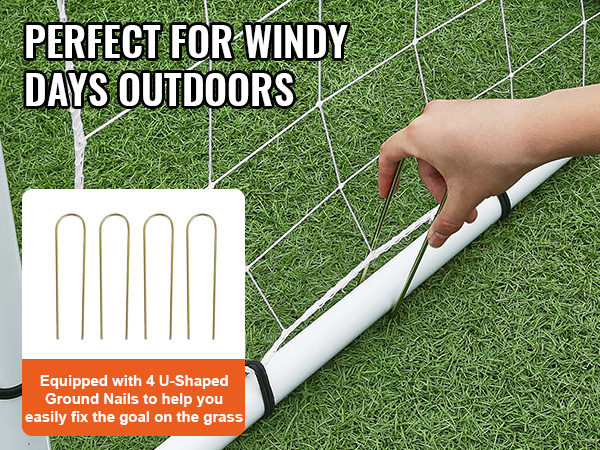 hand securing VEVOR soccer rebound trainer with u-shaped ground nails on grass for stability in windy conditions.