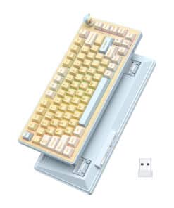 Pastel-toned retro keyboard perched on a light blue vintage computer, with a USB dongle nearby